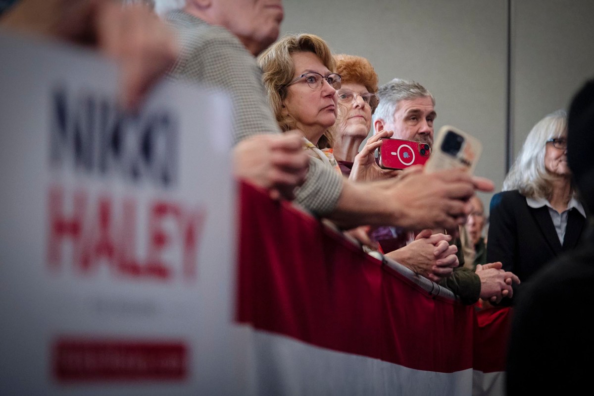 A group of people standing in front of a rally.
