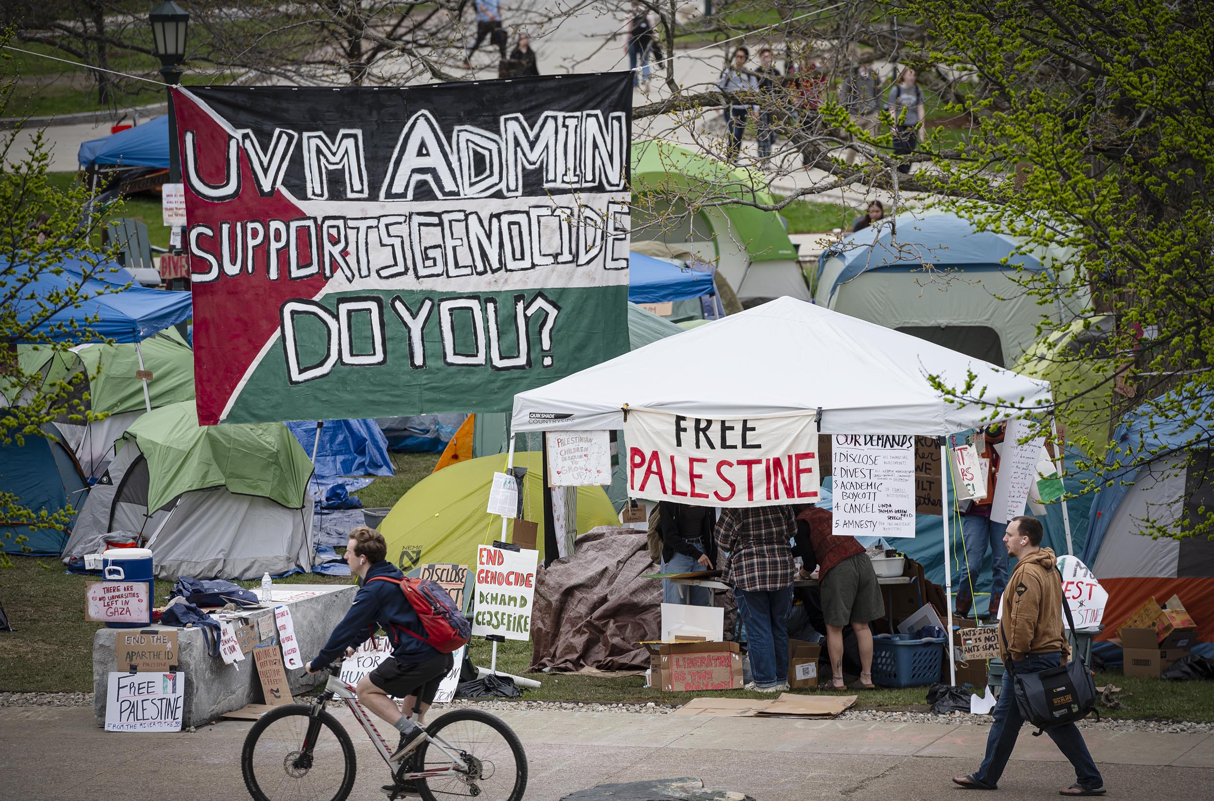 A protest camp with banners stating 