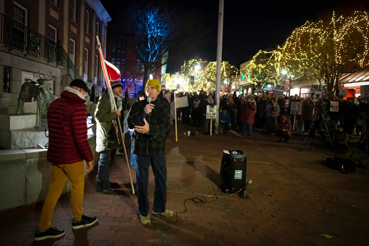 A group of people standing in front of a building at night.