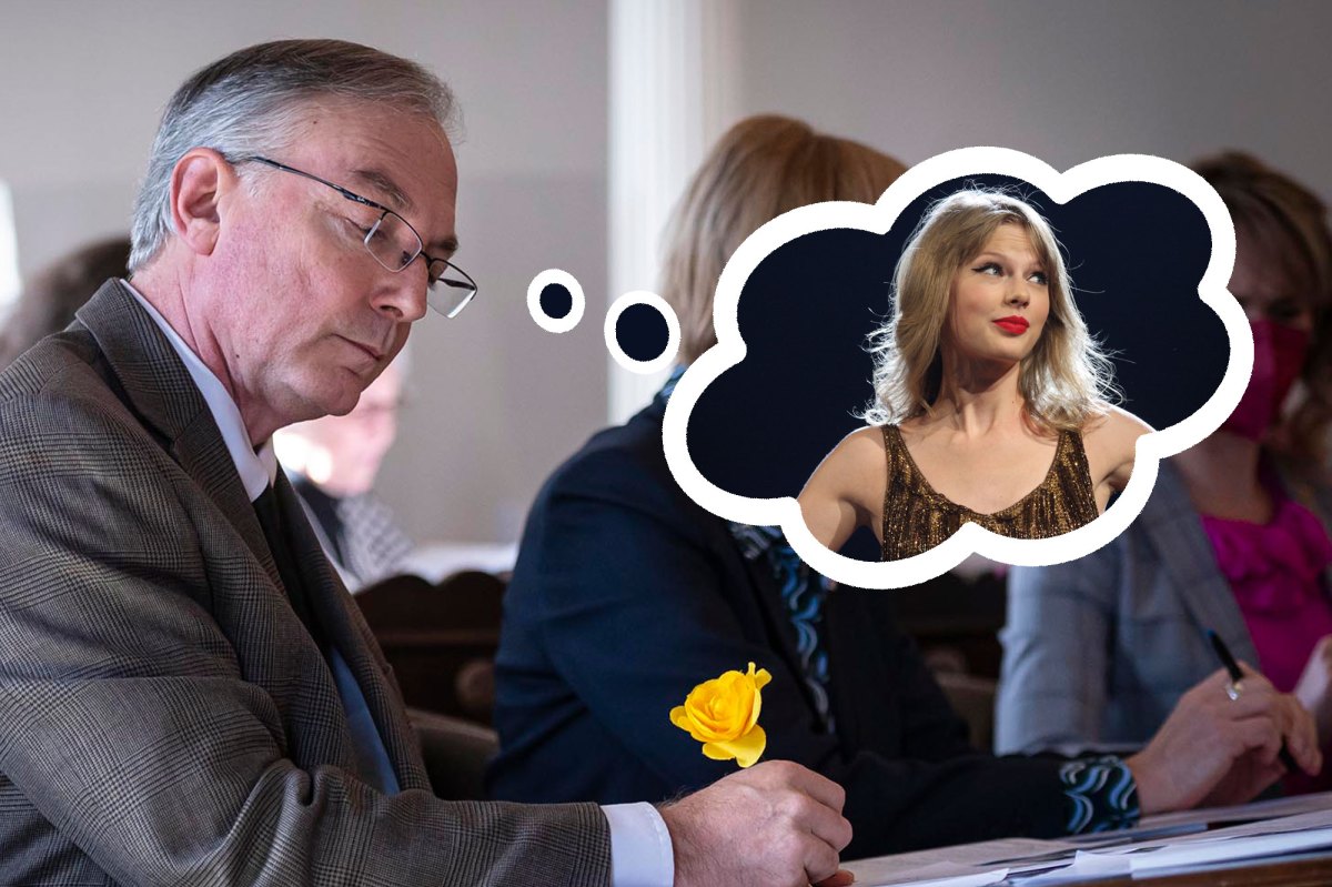 A photo of a man at a desk with a photoshopped thought bubble of Taylor Swift.