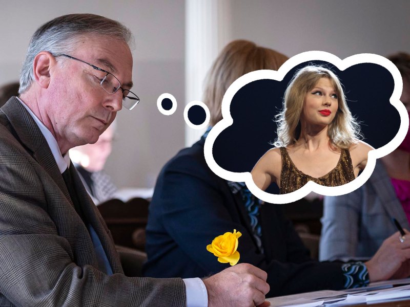 A photo of a man at a desk with a photoshopped thought bubble of Taylor Swift.