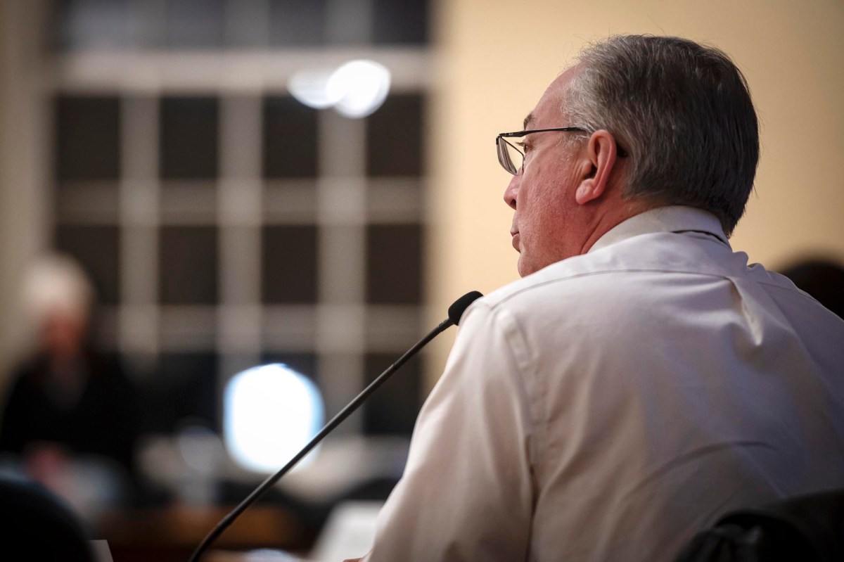A man sitting at a microphone.