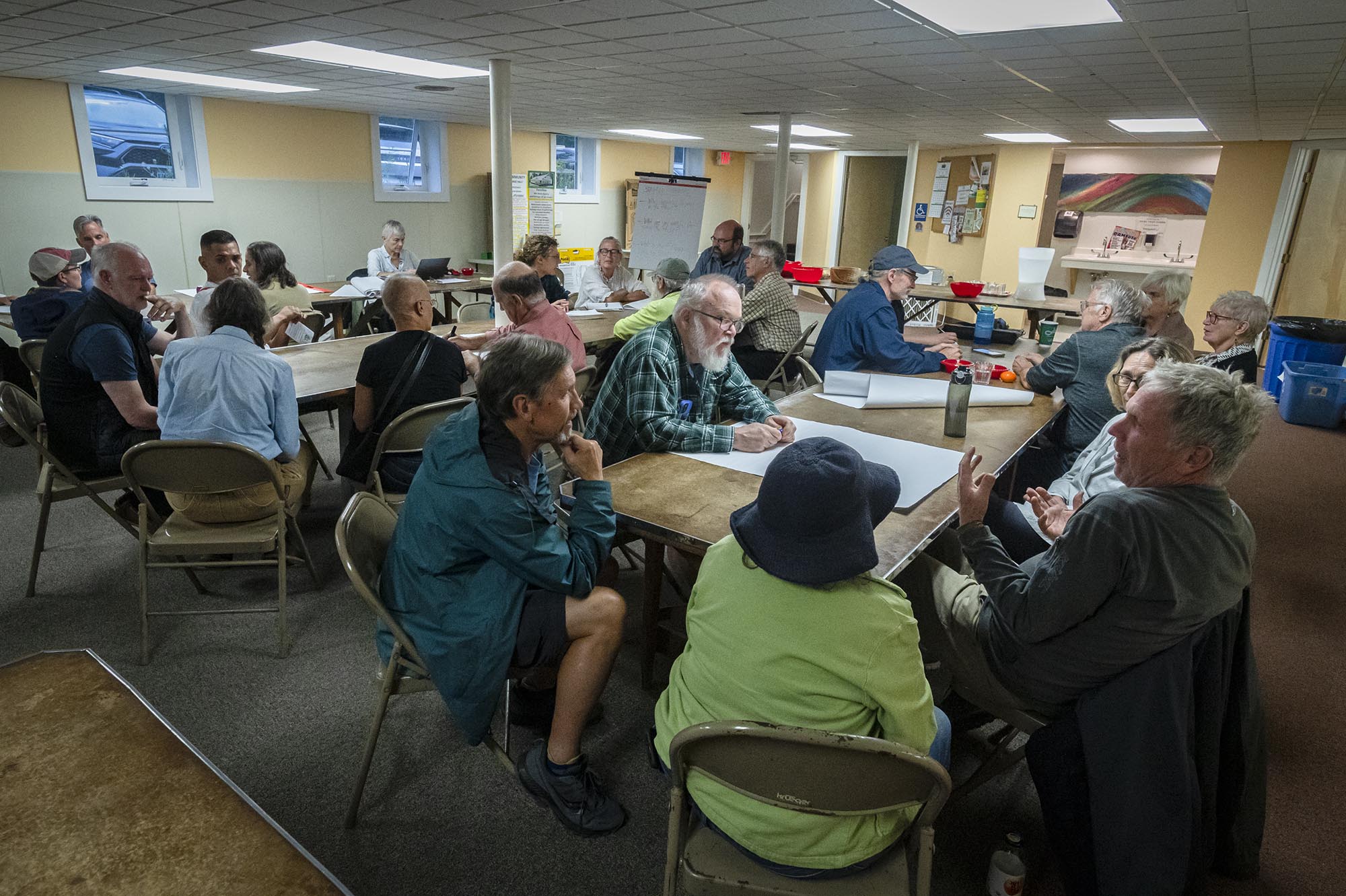 A group of people sitting around a table in a room.