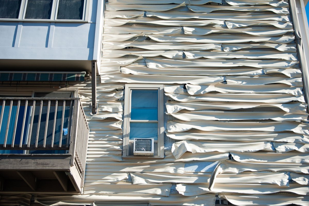 Warped cream-colored siding.
