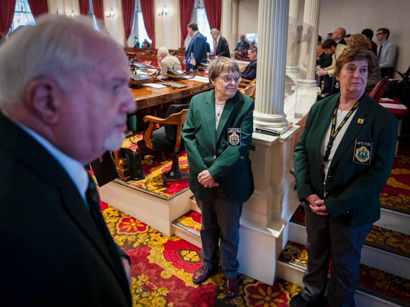 A group of people standing in a room.