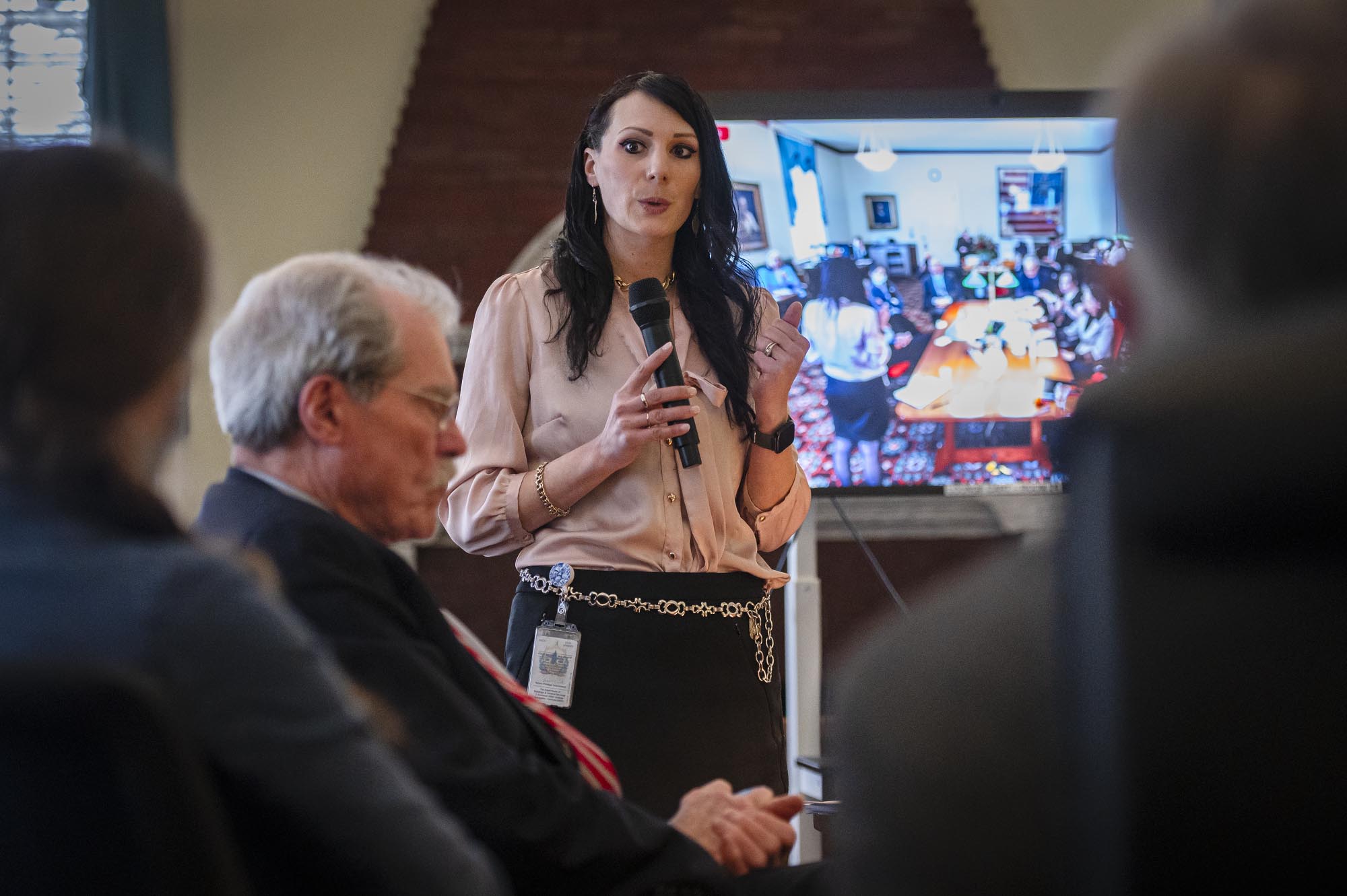 A woman is giving a presentation to a group of people.