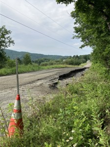 a road with a cone in the middle of it.