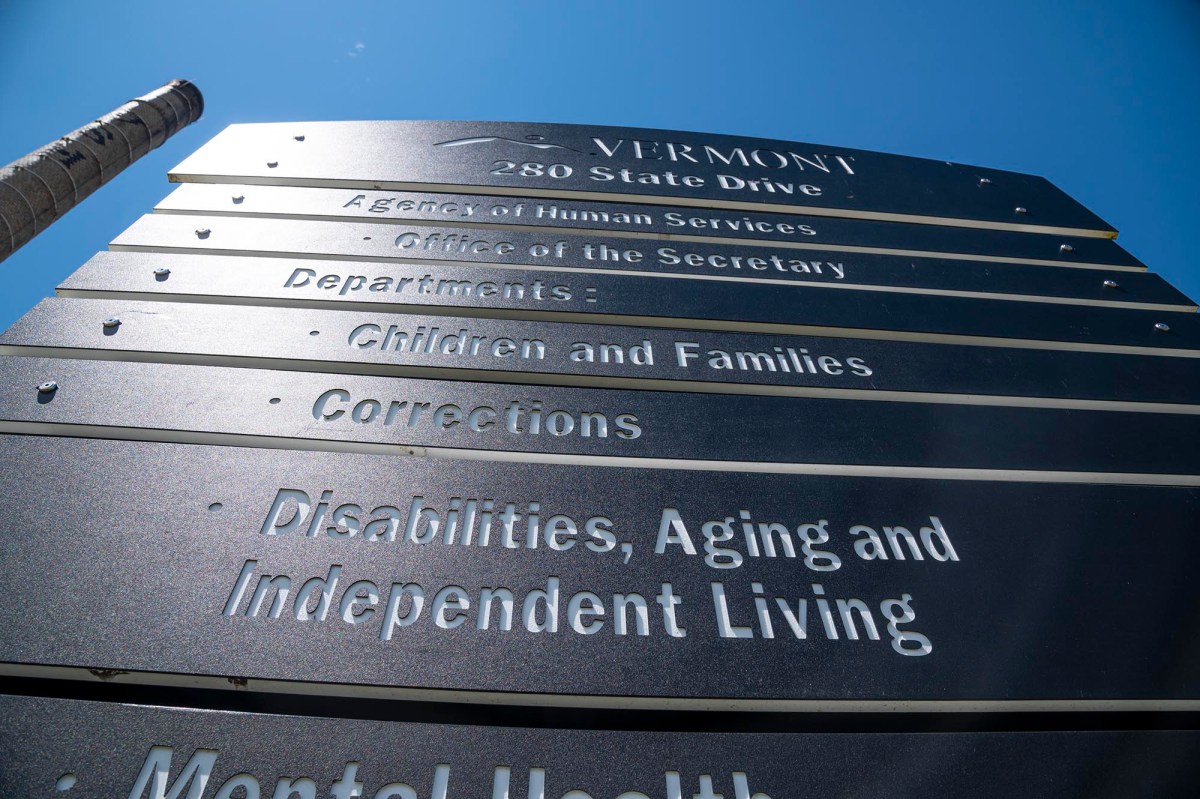 a large metal sign on the side of a building.