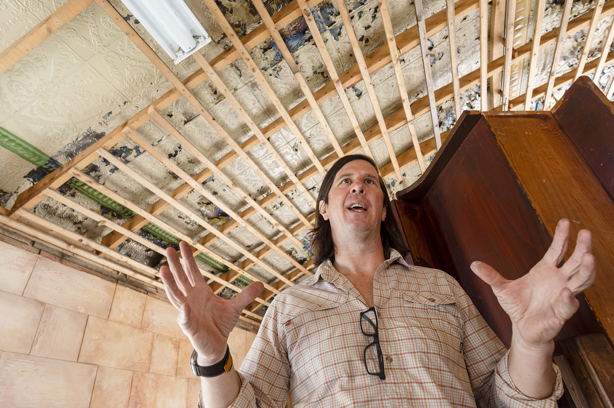 A man is standing in the middle of a room.