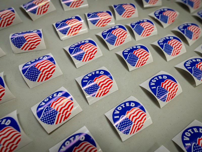 A group of voting stickers are arranged on a table.
