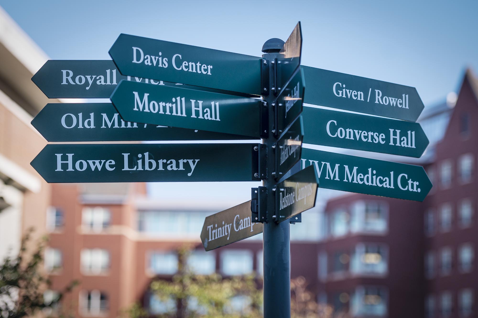 A group of street signs pointing in different directions.