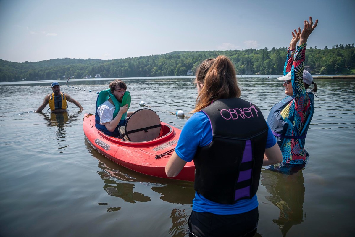 A group of people in a red canoe on a lake.