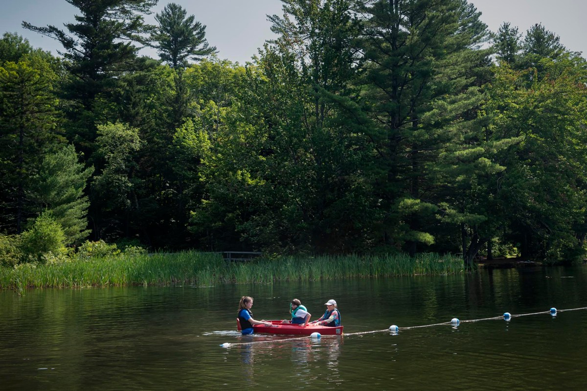 A group of people in a canoe on a lake.