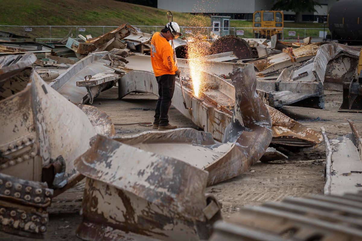 A man is welding a piece of metal.