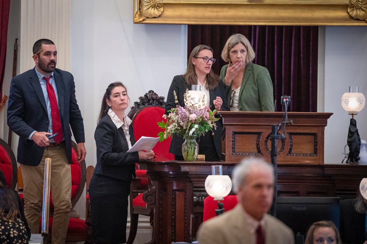 a group of people standing around a table.