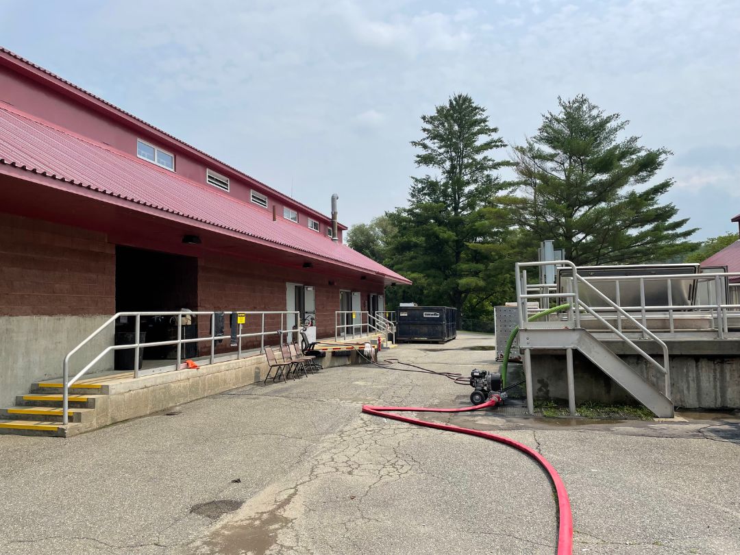 a building with a red hose in front of it.
