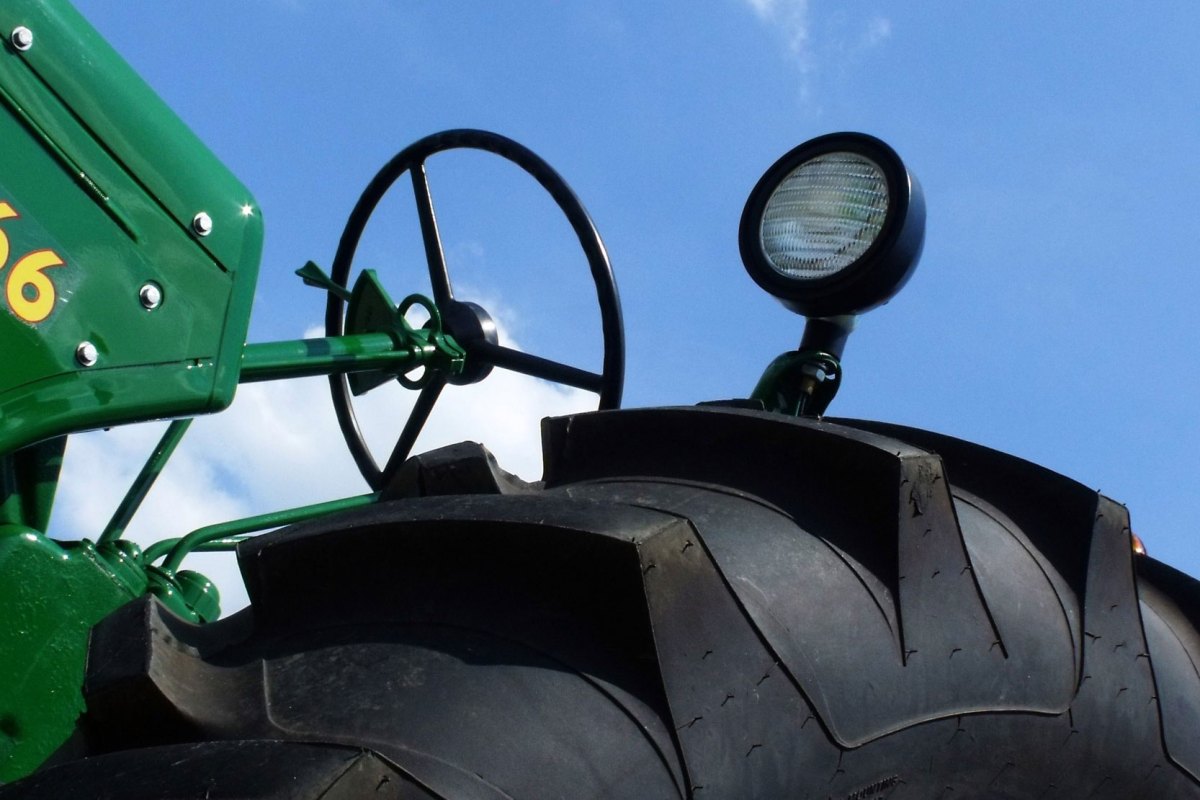 A close up of a tire and steering wheel of a tractor.