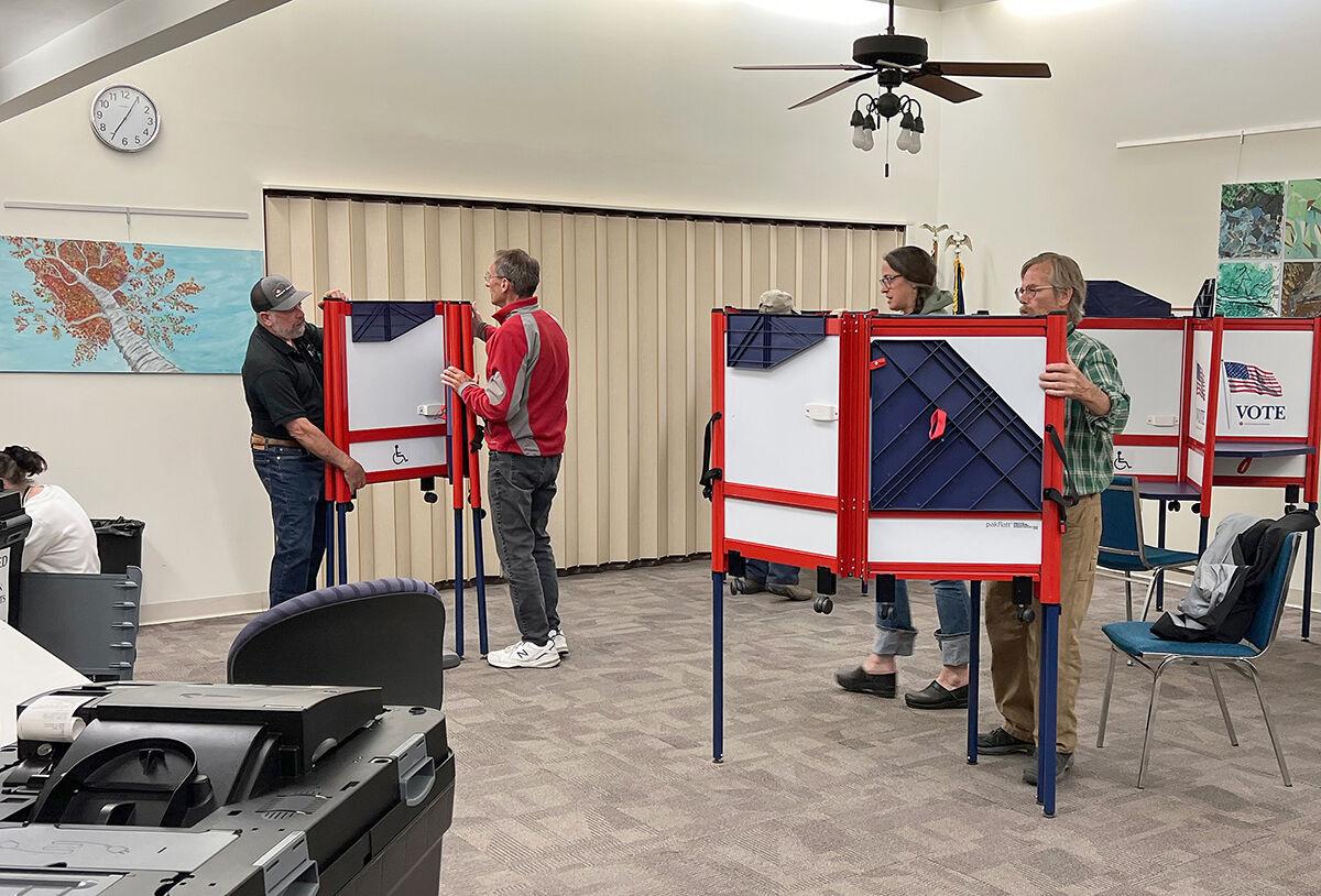 a group of people standing around a room.