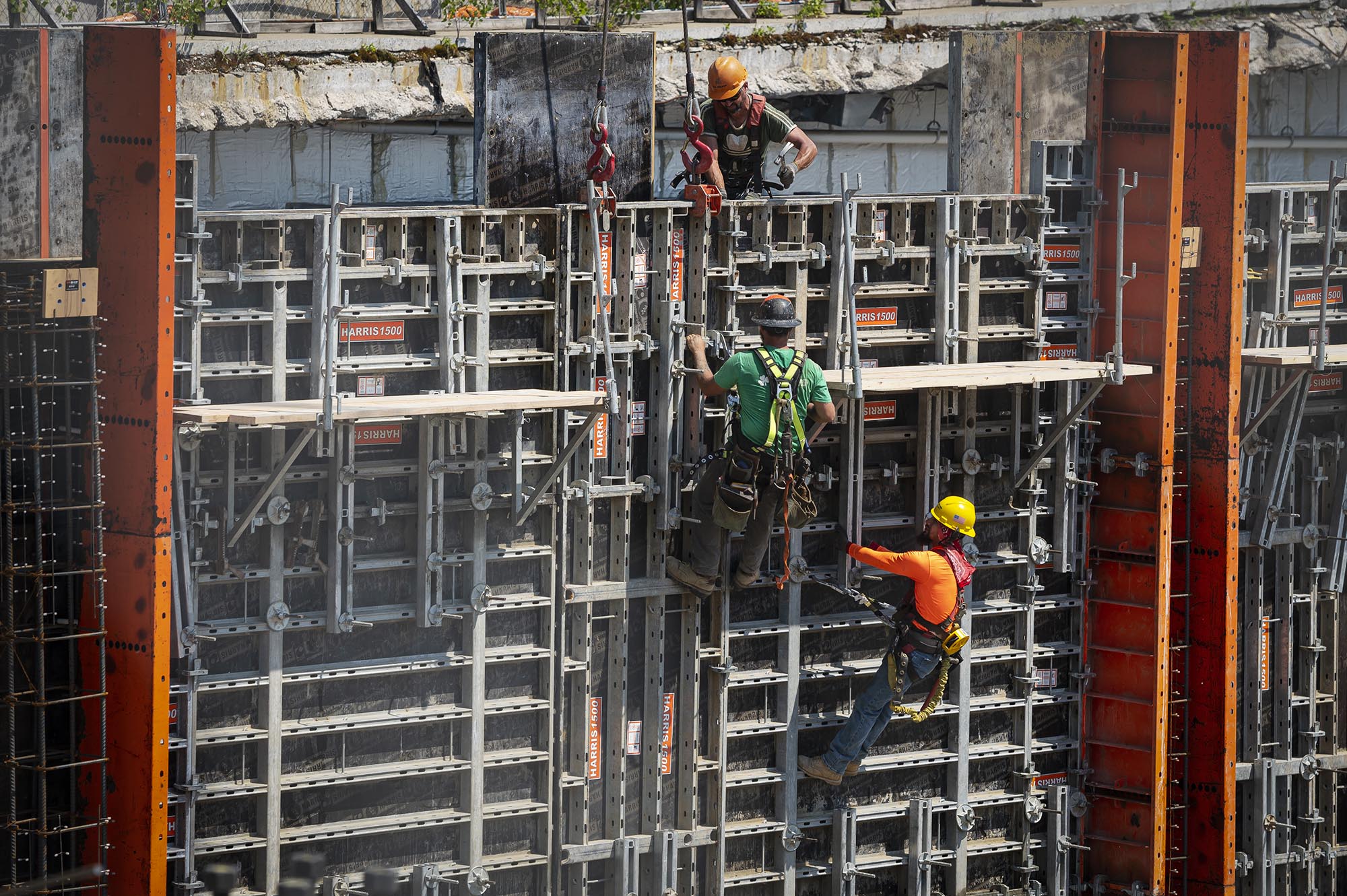 a group of construction workers working on a building.