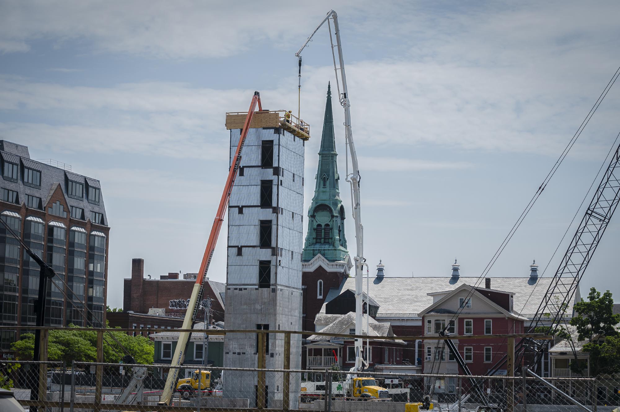 a tall building with a clock tower in the background.
