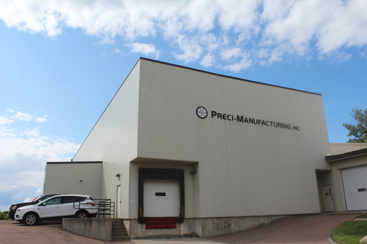 A beige building against a cloudy blue sky.