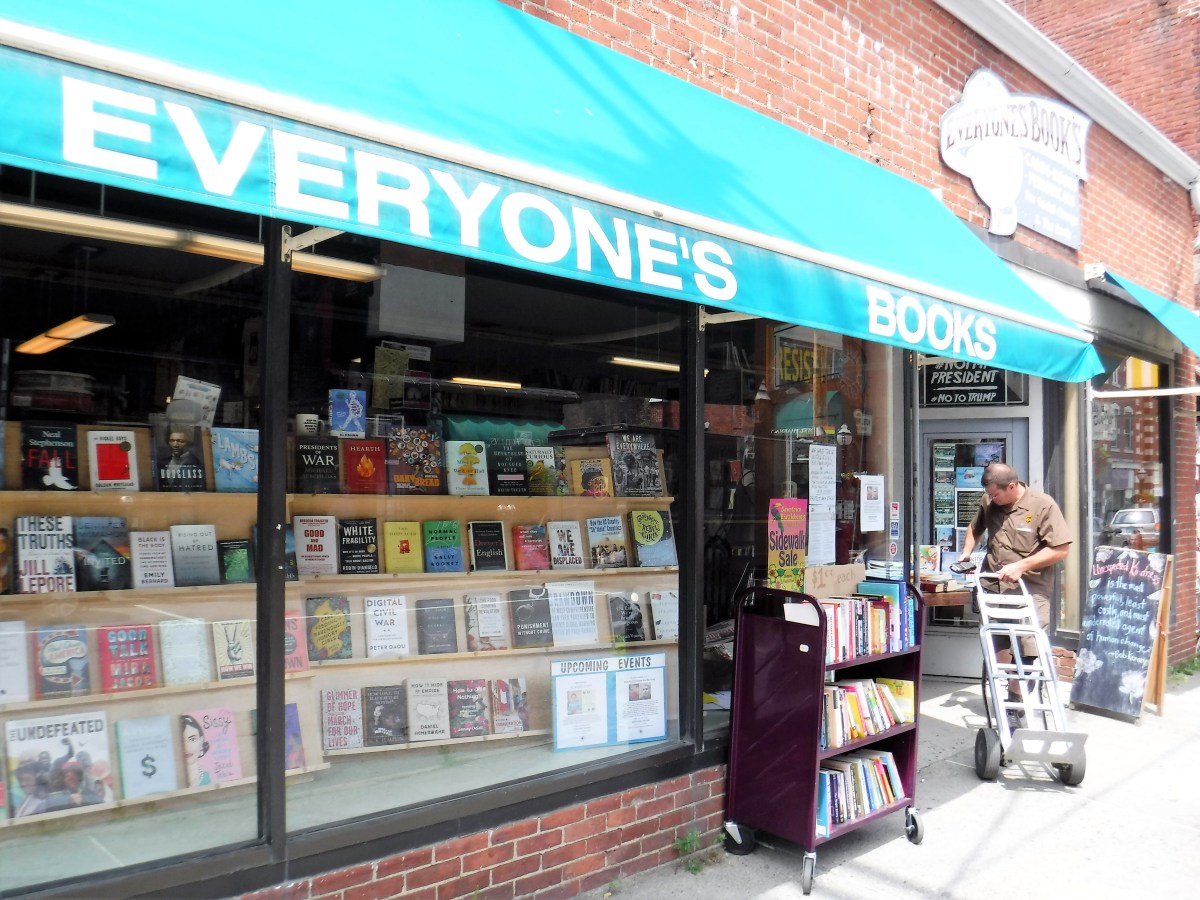 A storefront with a green awning.