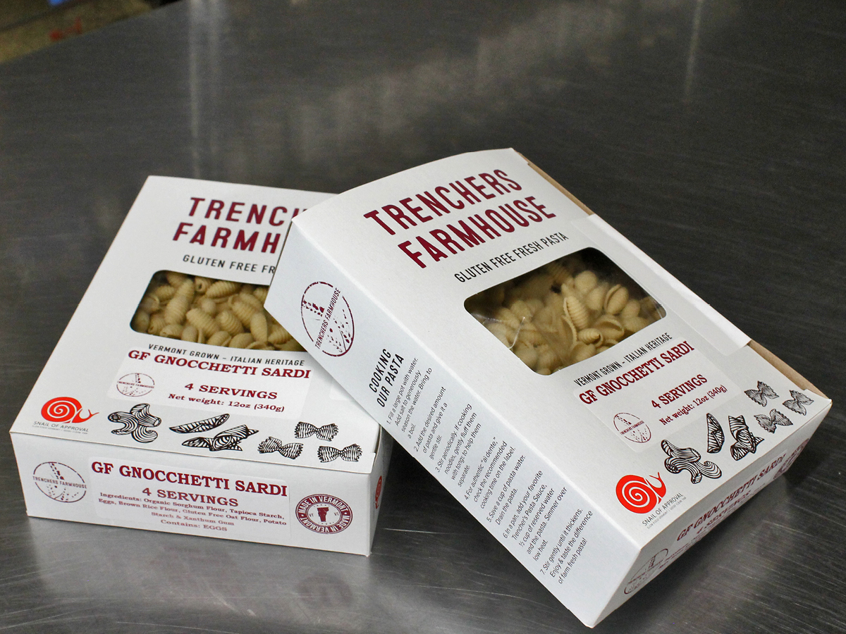 Two boxes of pasta sitting on a table.