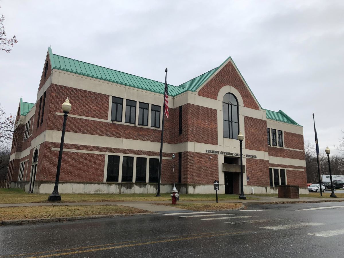 A brick building with a green roof.