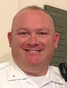 A man smiling in front of the camera.