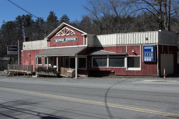 A red building on the side of a road.