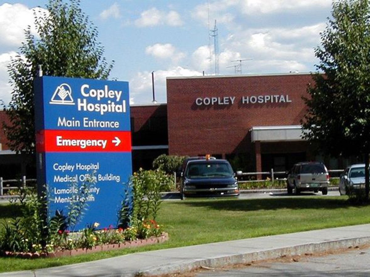 Directional sign at the entrance of copley hospital with an arrow pointing to the emergency room.
