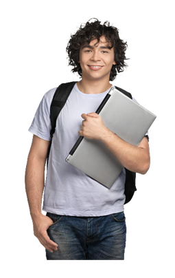Young man with curly hair smiling, holding a laptop and wearing a backpack, standing against a gray background.
