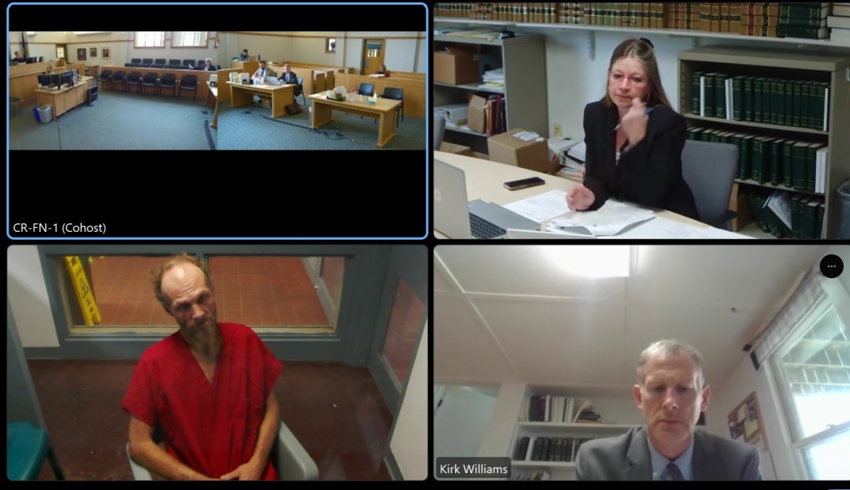 A virtual courtroom session with four participants shown in separate video feeds: courtroom, a woman at a desk, a man in a red robe, and a man labeled as "Kirk Williams.
