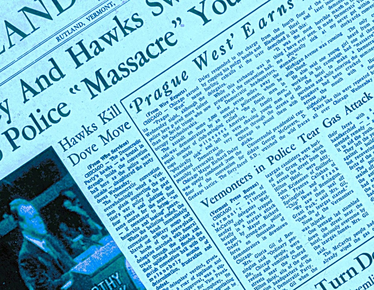 Close-up of a newspaper with prominent headlines including "Prague West Earns," "Hawks Kill Dove Move," and "Vermonters in Police Tear Gas Attack." Articles and text are densely packed on the page.