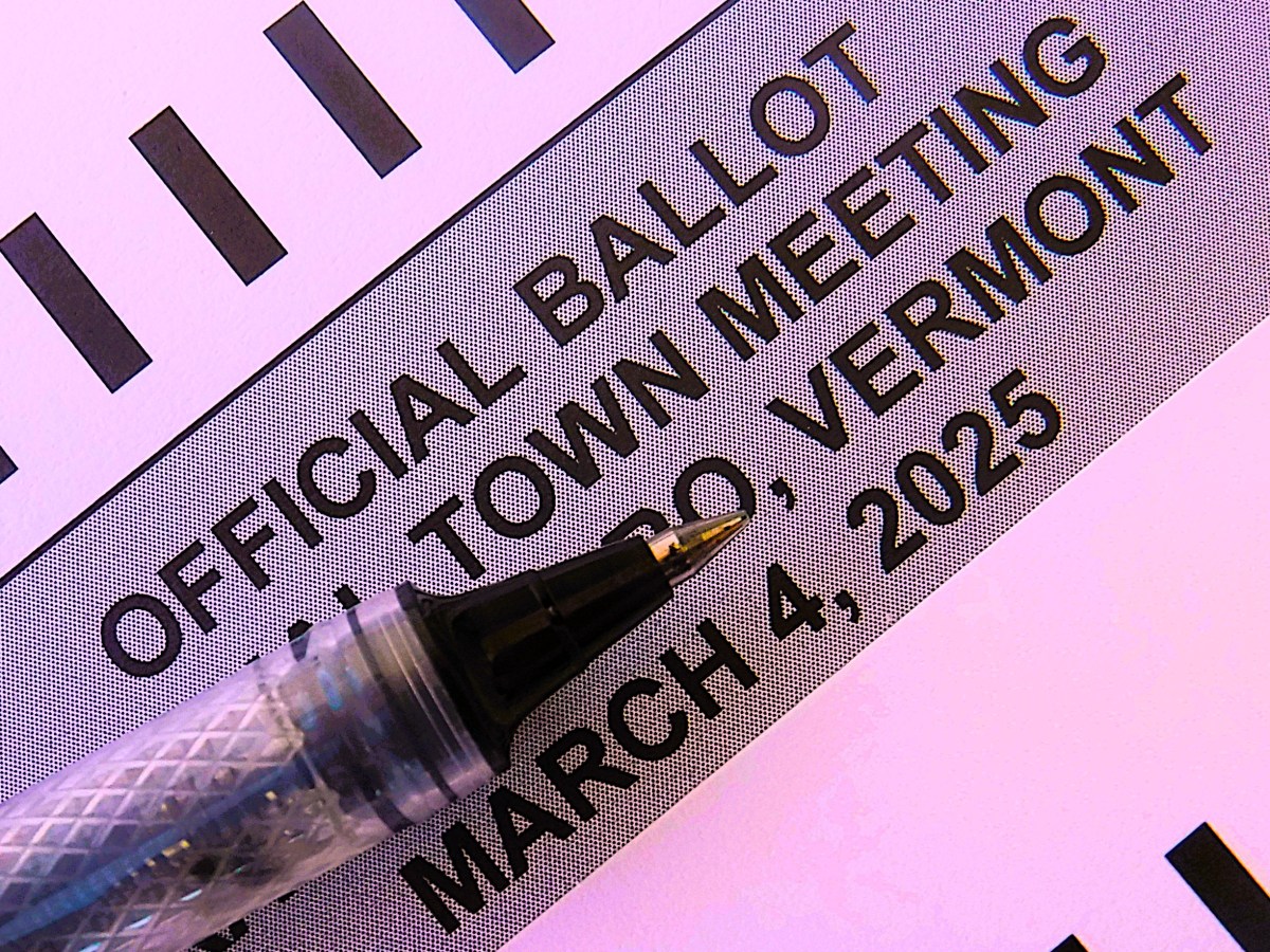 Close-up of a pen resting on an official ballot for a town meeting in Vermont, dated March 4, 2025.