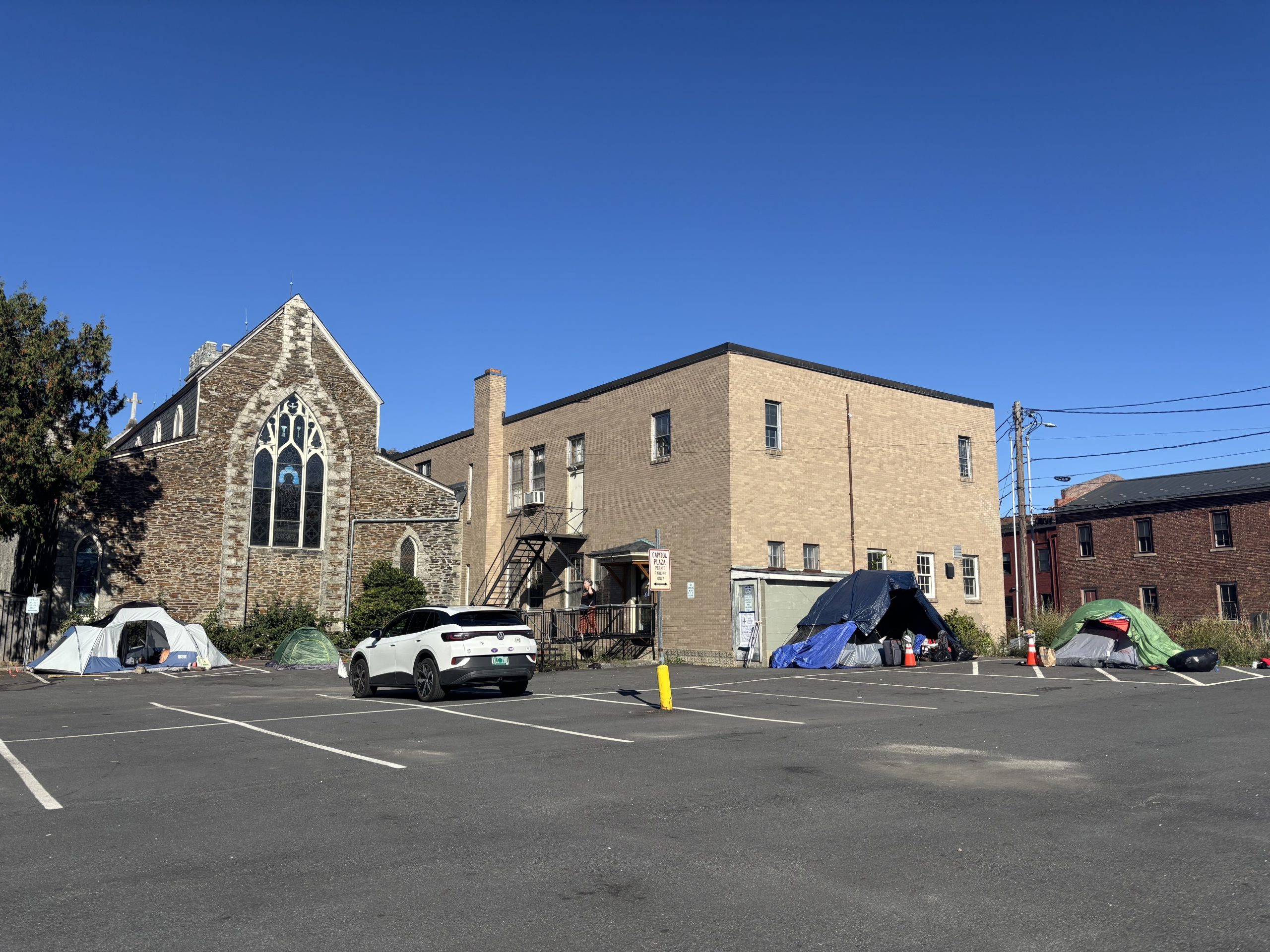 A building with tents in front of it.