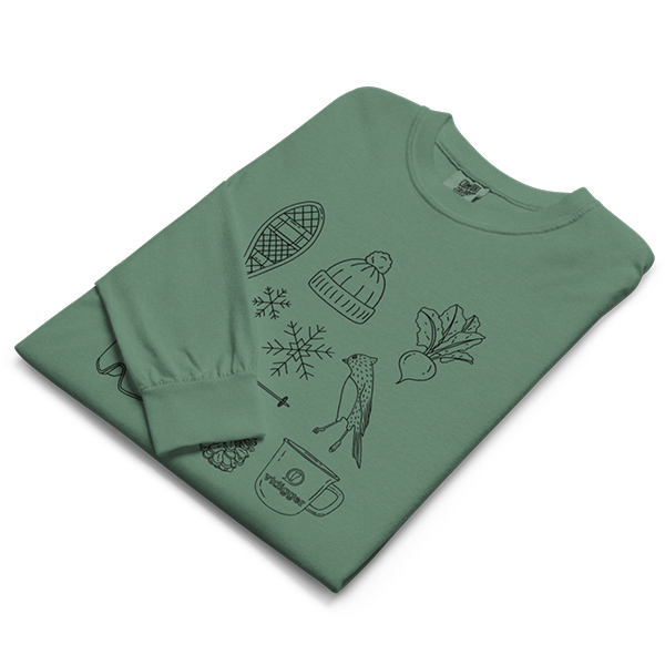 A folded green long sleeve t-shirt featuring black line drawings of winter and nature-themed items