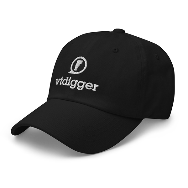 A black baseball cap displaying the white embroidered text "vtdigger" and a circular logo on the front.