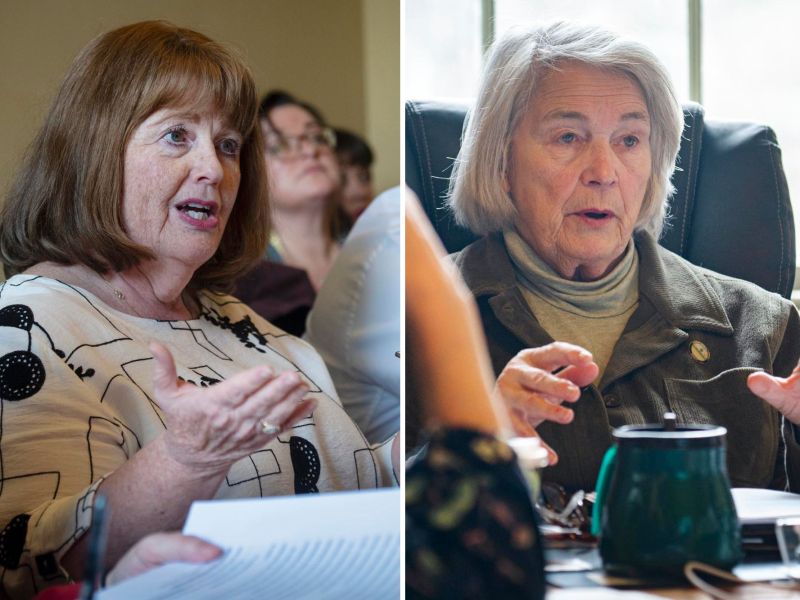 Two older women speaking in separate indoor settings, each gesturing with their hands while seated at tables with papers and a mug visible.