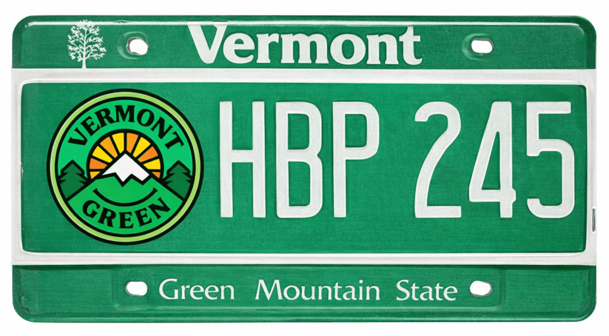 A Vermont license plate with the text "Vermont" at the top, "HBP 245" in the center, and "Green Mountain State" at the bottom. A "Vermont Green" logo is on the left.