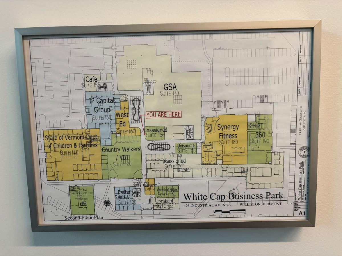 Framed floor plan of White Cap Business Park with various suites labeled, highlighting a "You Are Here" marker in red near the center.