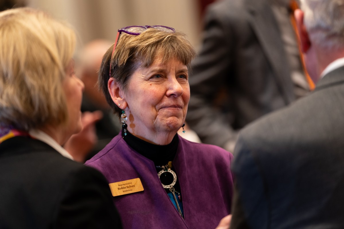 Rep. Robin Scheu speaks with fellow lawmakers on the first day of the 2026 Vermont legislative session, Tuesday, Jan. 6. Photo by Brian Stevenson/Vermont Public