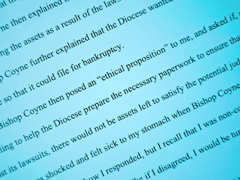 A close-up of a printed document with highlighted text discussing bankruptcy and an "ethical proposition" posed by Bishop Coyne.