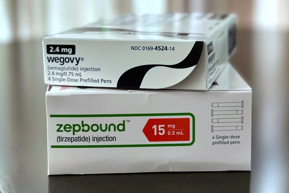 Two boxes of injectable medications, Wegovy (semaglutide) 2.4 mg and Zepbound (tirzepatide) 15 mg, are stacked on a reflective surface.