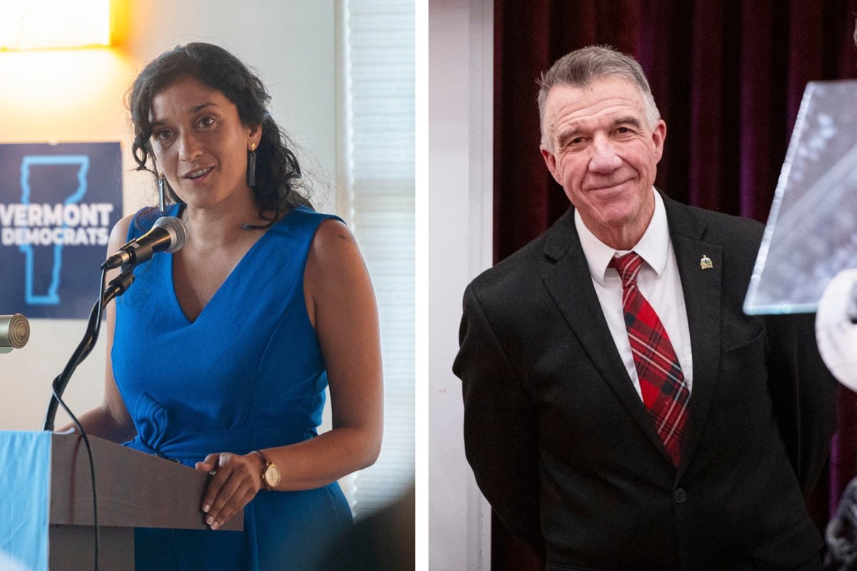 Two people are shown: a woman speaking at a podium on the left with a “Vermont Democrats” sign, and a man in a suit and plaid tie standing on the right.