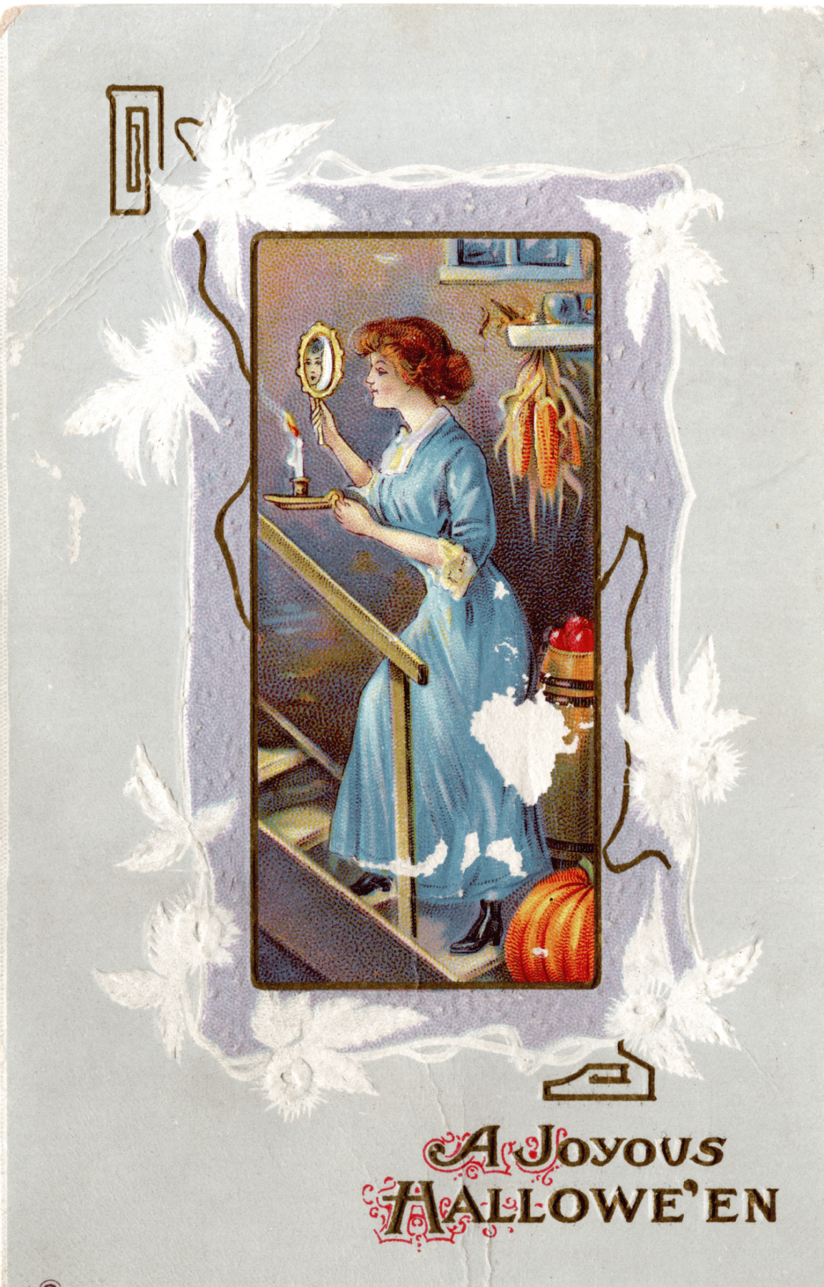 Vintage Halloween postcard showing a woman in a blue dress holding a candle and a small mirror while walking down stairs, with the text “A Joyous Hallowe’en” at the bottom.