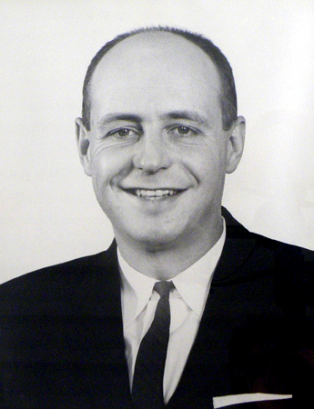Portrait of a smiling man in a suit and tie.